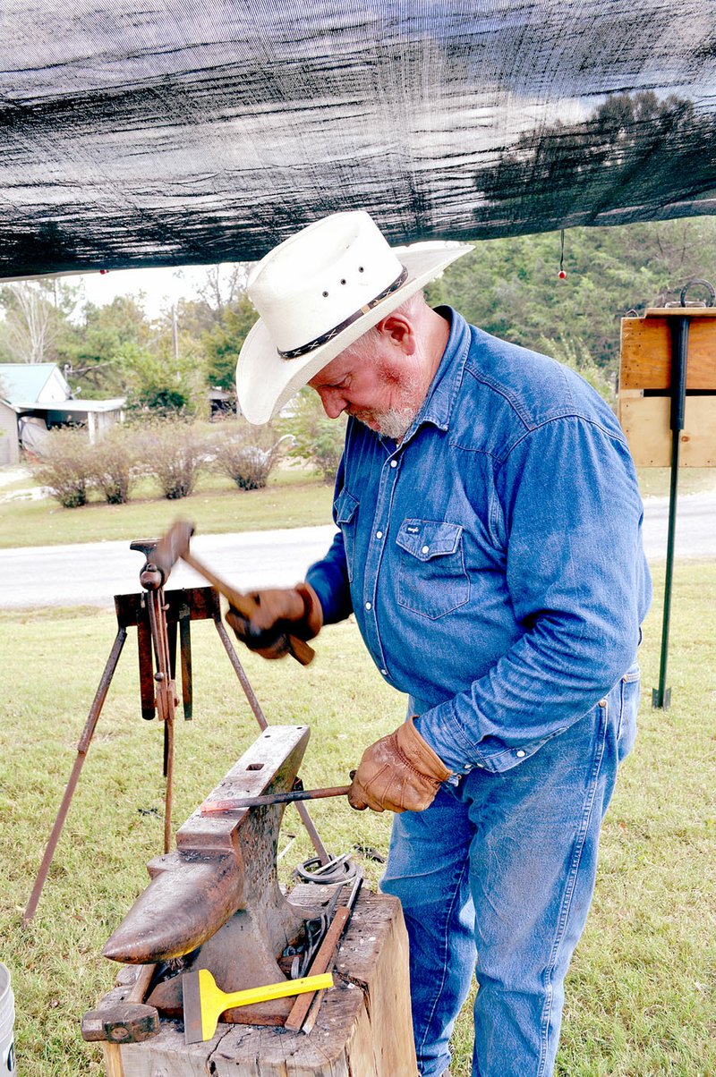 RACHEL DICKERSON/MCDONALD COUNTY PRESS Robert Bechdolt of Neosho puts on a blacksmithing demonstration at the New Bethel School Old Time Craft Fair on Saturday.
