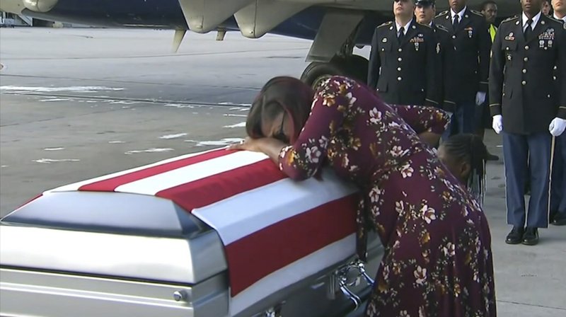 In this Tuesday, Oct. 17, 2017, frame from video, Myeshia Johnson cries over the casket in Miami of her husband, Sgt. La David Johnson, who was killed in an ambush in Niger. President Donald Trump told the widow that her husband &quot;knew what he signed up for,&quot; according to Rep. Frederica Wilson who said she heard part of the conversation on speakerphone. (WPLG via AP)