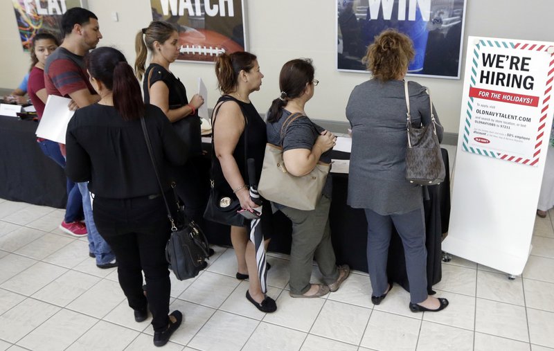 In this Oct. 3 photo, job seekers wait in line at a job fair at the Dolphin Mall in Sweetwater, Fla. The Labor Department said Thursday that claims for jobless aid dropped by 22,000 to 222,000, fewest since March 1973. (AP Photo/Alan Diaz)
