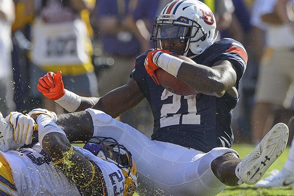 Auburn running back Kerryon Johnson (21) rushes against LSU linebacker Corey Thompson (23) in the first half during an NCAA college football game in Baton Rouge, La., Saturday, Oct. 14, 2017. (AP Photo/Matthew Hinton)

