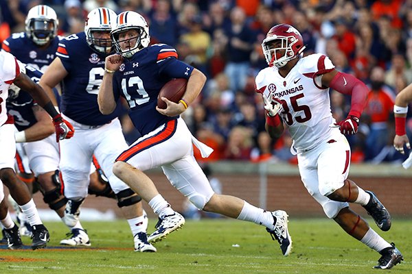 Auburn quarterback Sean White (13) scrambles for a run as Arkansas linebacker Dwayne Eugene (35) gives chase during the first half of an NCAA college football game against Arkansas, Saturday, Oct. 22, 2016, in Auburn, Ala. (AP Photo/Butch Dill)
