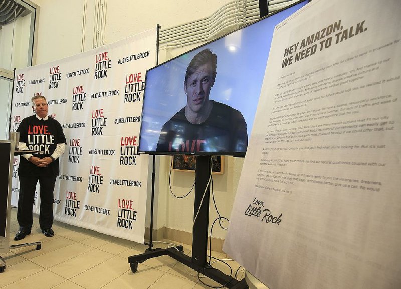 Jay Chesshir, president and chief executive officer of the Little Rock Regional Chamber of Commerce, watches a video Thursday in The Venture Center at the Little Rock Technology Park tied to the chamber’s Amazon-themed program to attract new businesses.