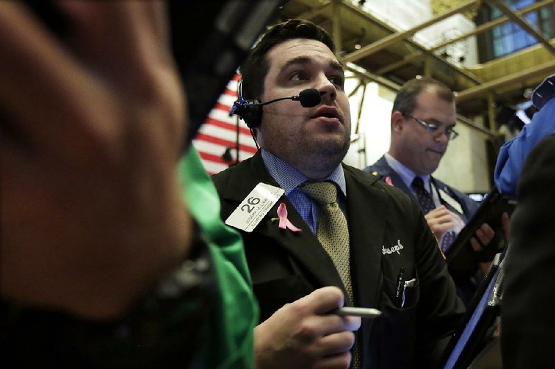 Trader Joseph Lawler works Thursday on the fl oor of the New York Stock Exchange where the Standard & Poor’s 500 index and Dow Jones industrial average closed higher for the fi fth straight day.