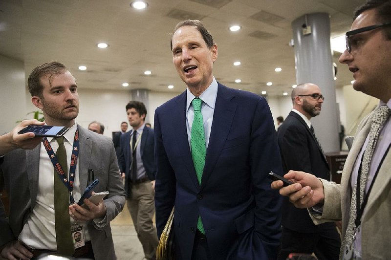 Sen. Ron Wyden, D-Ore., the ranking member of the Senate Finance Committee, arrives Thursday at the Capitol for several votes. 