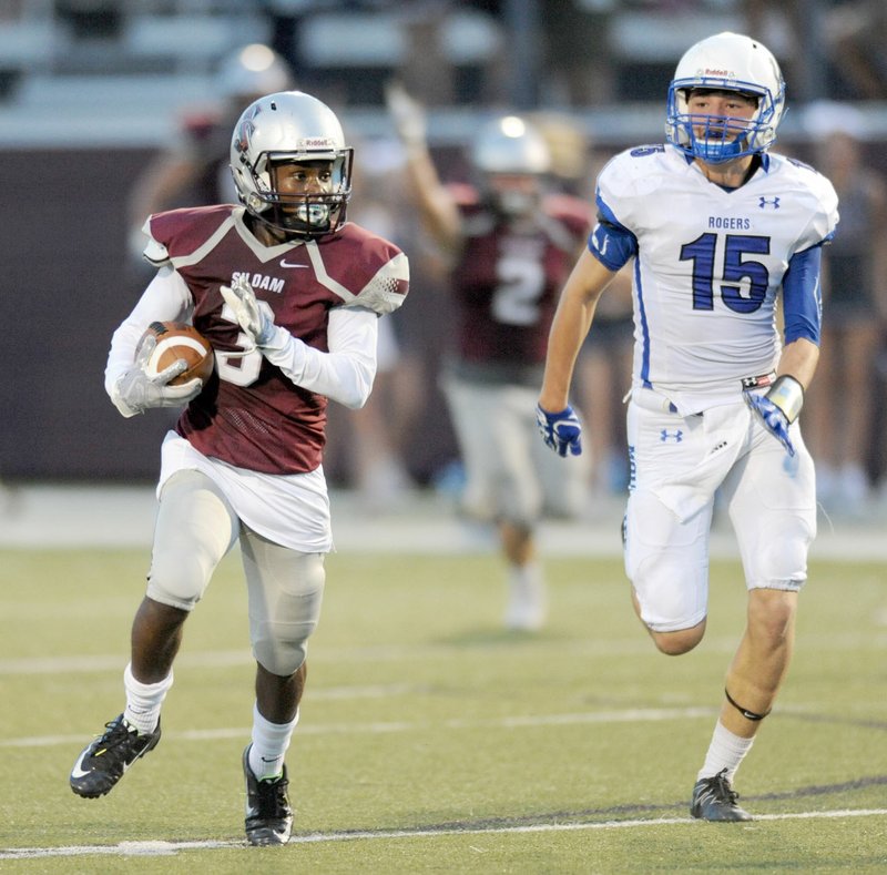 Siloam Springs’ Luke Gumm (3) tries to outrun Rogers High’s Shane Taylor as he returns a punt Sept. 1 at Panther Stadium in Siloam Springs. Gumm made it all the way to the 6-yard line on the return, which set up a Siloam Springs score.