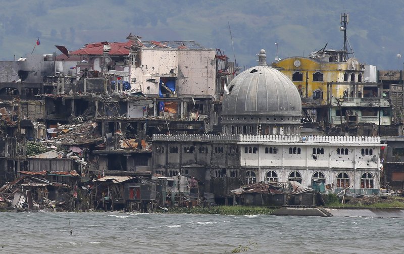 A mosque with its dome blasted out with holes is seen at the battle-scarred Marawi city in southern Philippines Thursday, Oct. 19, 2017. Two days after President Rodrigo Duterte declared the liberation of Marawi city, the military announced the killing of more suspected militants in the continuing military offensive. (AP Photo/Bullit Marquez)