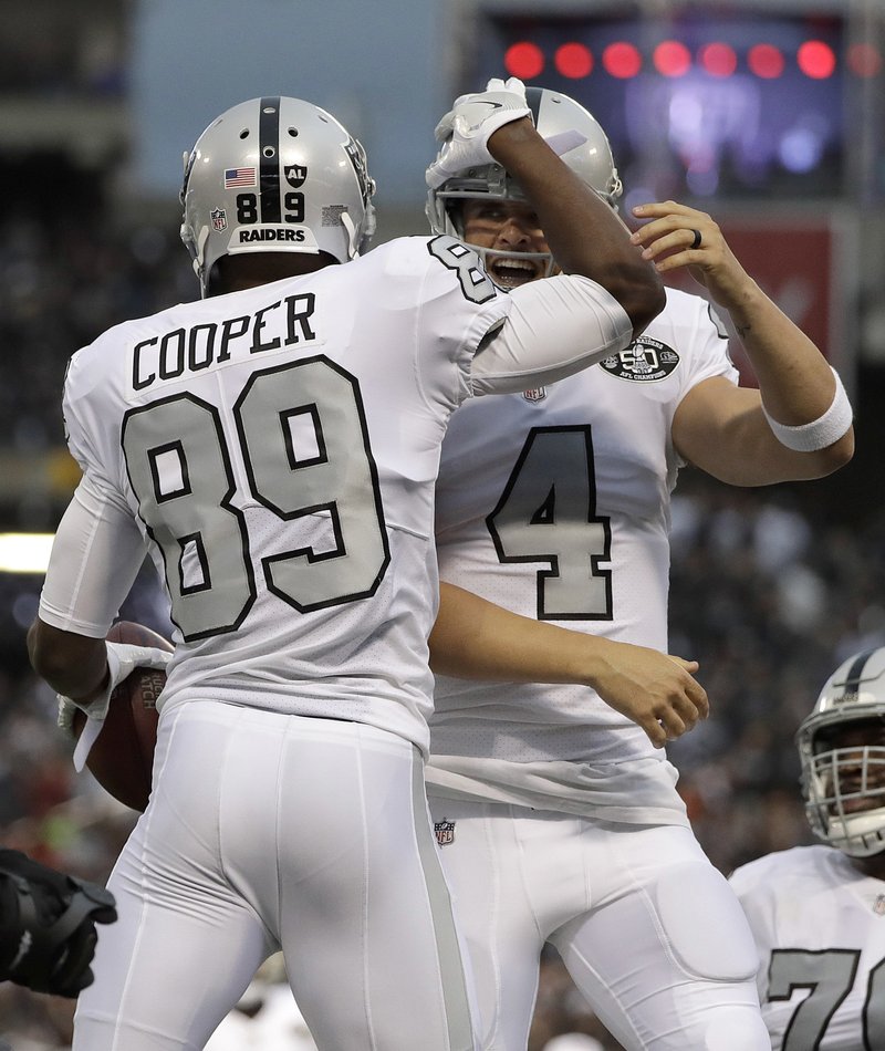 Raiders wide receiver Amari Cooper (89) and quarterback Derek Carr celebrate Thursday after connecting on a touchdown pass against the Chiefs in Oakland, Calif.