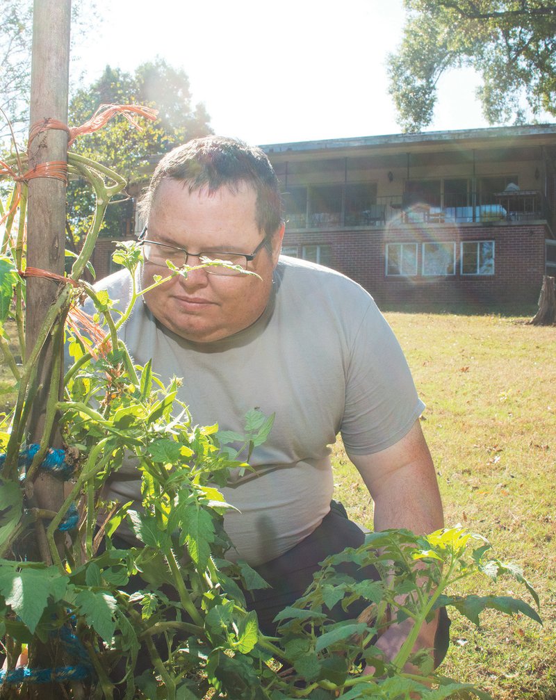 Volunteer Jimmy Cooper works in the garden behind the new men’s transitional home, Road to Damascus, in Searcy. The main purpose of the house is to give homeless men a safe place to stay while getting back on their feet, Cooper said.