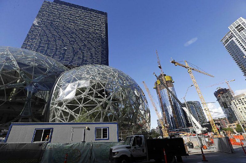 In this photo  taken in early October, large spheres take shape in front of an Amazon building in Seattle while construction also ensues across the street.