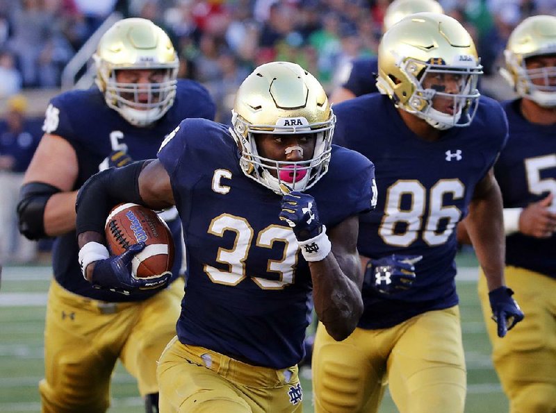 In this Sept. 30, 2017, file photo, Notre Dame running back Josh Adams heads for the end zone on a touchdown run during the first half of an NCAA college football game against Miami (Ohio) in South Bend, Ind.