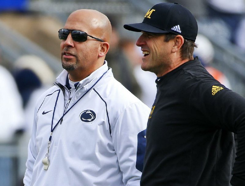 Michigan Coach Jim Harbaugh (right) and the No. 19 Wolverines face “a well-built team” in Coach James Franklin’s second-ranked Penn State Nittany Lions today in State College, Pa.