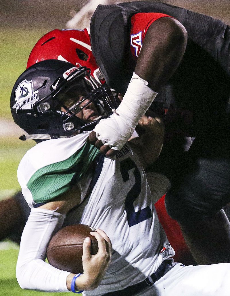 Little Rock Christian quarterback Jackson Bowersock (2) gets taken down by McClellan nose guard Dontorius Hickey on Friday at Little Rock Central High School.