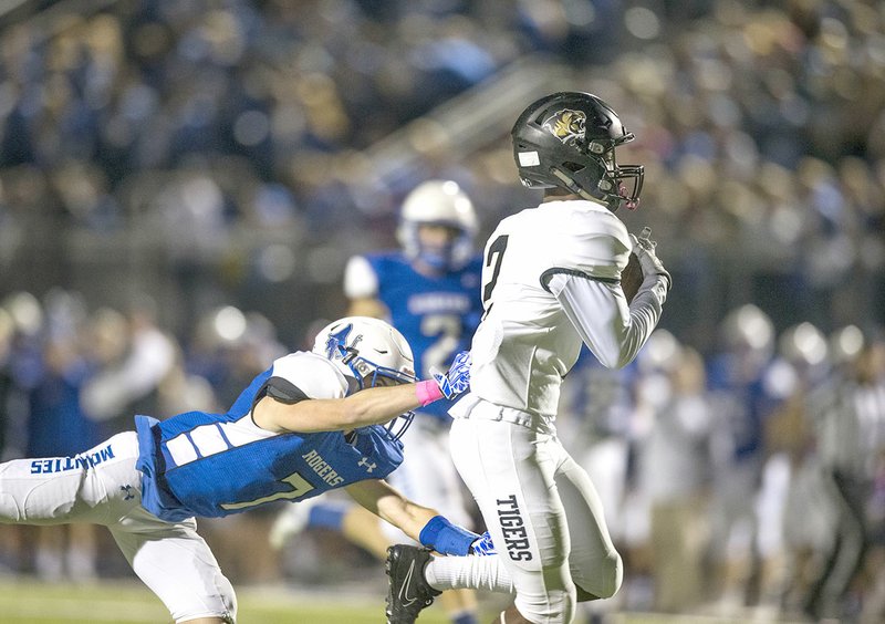 Bentonville High receiver Kam'ron Mays-Hunt (2) hauls in a touchdown pass ahead of Rogers High defensive back Logan Watkins on Friday at Whitey Smith Stadium in Rogers.