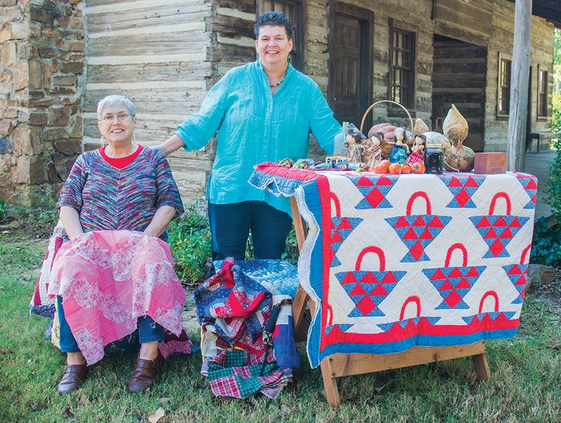 Lynita Langley-Ware, standing, director of the Faulkner County Museum, and her mother, Linda Langley, who is a museum volunteer, a member of the Town and Country Garden Club and a quilter, show some of the craft items that will be featured at the open house. Activities are planned from 
10 a.m. to 4 p.m. Nov. 4 inside the museum and outside on the grounds with the 1850-era dogtrot cabin as a focal point.