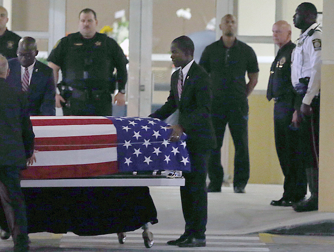 The casket of Sgt. La David T. Johnson of Miami Gardens, who was killed in an ambush in Niger. is wheeled out after a viewing at the Christ The Rock Church, Friday, Oct. 20, 2017 in Cooper City, Fla. (Pedro Portal/Miami Herald via AP)