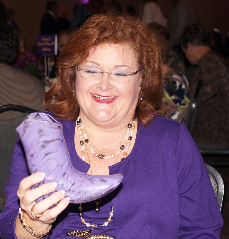 The Glass Boot: Mary Pat Cook Anthony shows the glass boot she received as the 2017 ‘Stepping Up for Ouachita’ honoree at a luncheon Thursday. The event is held annually to honor an alumna of Ouachita Baptist University and raise funds to provide scholarships for female students to attend OBU. See more photos on page 8A.