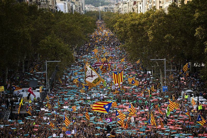 People flood the streets of Barcelona, Spain, on Saturday in what began as a protest against the jailing of pro-independence activists and turned into an outcry over the central government’s move to take over the Catalonia region.