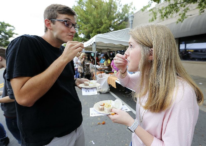 Luke McHan and his wife, Lara, sample cornbread before voting for the winners during the 2017 Arkansas Cornbread Festival on Saturday in Little Rock.