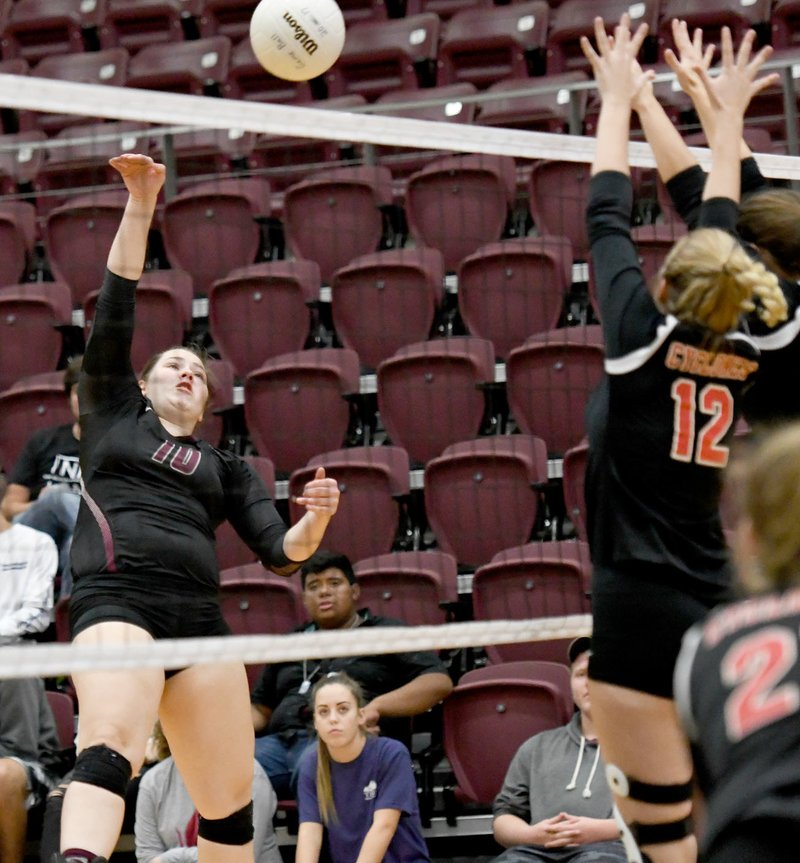 Bud Sullins/Special to Siloam Sunday Siloam Springs senior Allie Bowman, left, goes up for a hit over Russellville's block on Thursday at the Panther Activity Center.