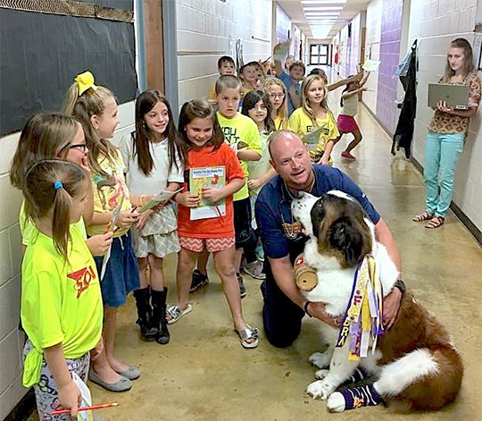 Submitted photo Dr. Brian Peters, veterinarian and owner of Lake Hamilton and Hot Springs Animal Hospitals, and Zuri the St. Bernard recently visited second-grade students at Fountain Lake Elementary School for Career Day.