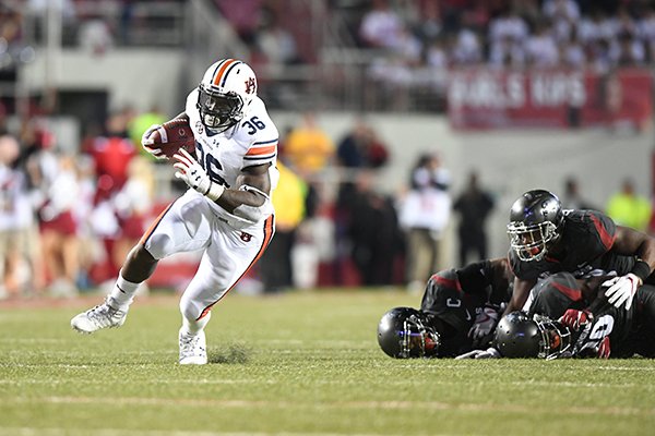 Auburn running back Kamryn Pettway runs away from a group of Arkansas defenders during a game Saturday, Oct. 21, 2017, in Fayetteville. 