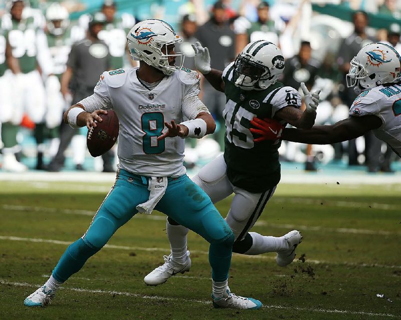 Miami Dolphins quarterback Matt Moore (8) led a fourth-quarter comeback after starter Jay Cutler left the game with a broken rib, and the Dolphins defeated the New York Jets 31-28 Sunday.