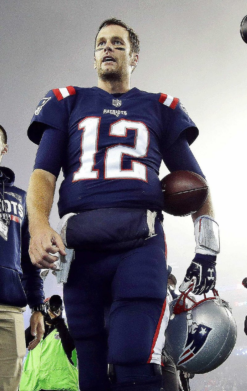 New England Patriots quarterback Tom Brady leaves a foggy field at Gillette Stadium after a 23-7 victory over the Atlanta Falcons on Sunday night.
