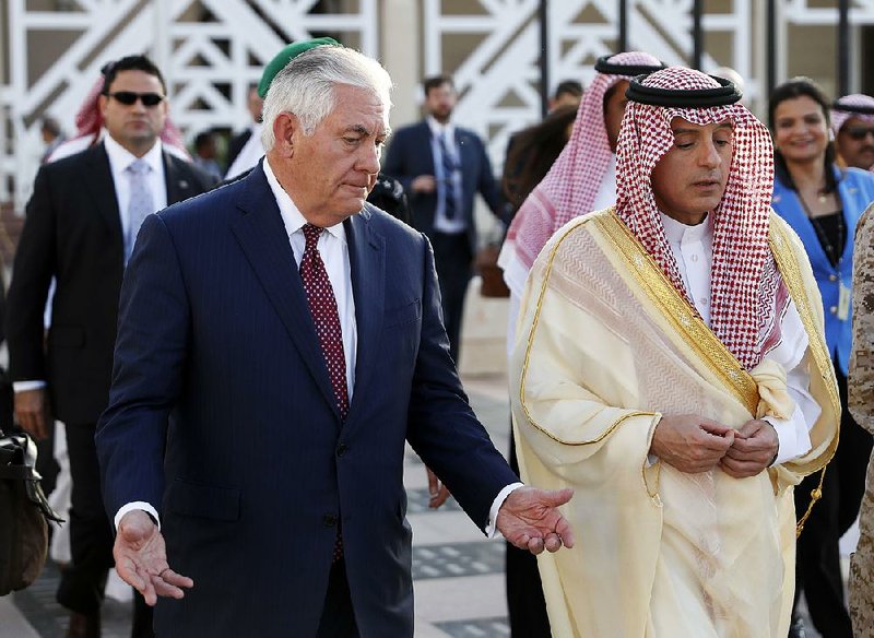 Secretary of State Rex Tillerson speaks with Saudi Foreign Minister Adel Ahmed Al-Jubeir after a news conference as Tillerson heads to his plane Sunday in Riyadh, Saudi Arabia.
