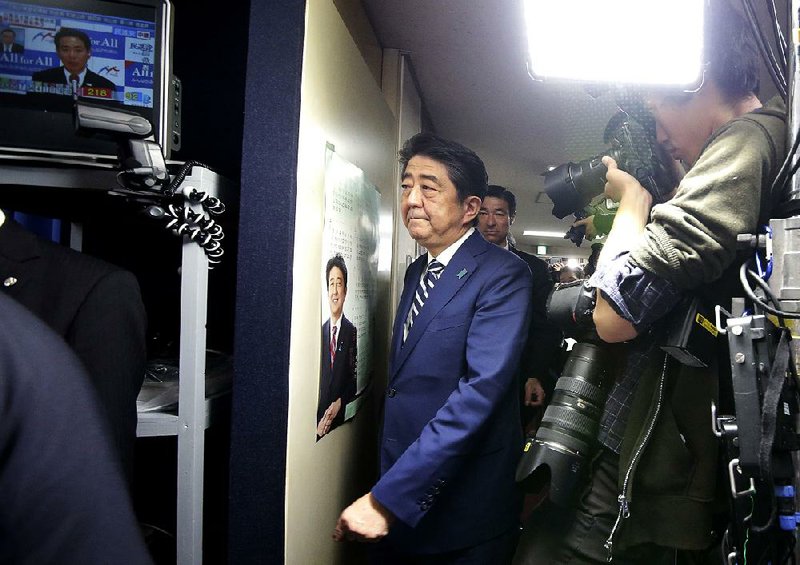 Japanese Prime Minister Shinzo Abe, leader of the Liberal Democratic Party, arrives at the party headquarters in Tokyo on Sunday for ballot counting in elections to Japan’s lower house of parliament.