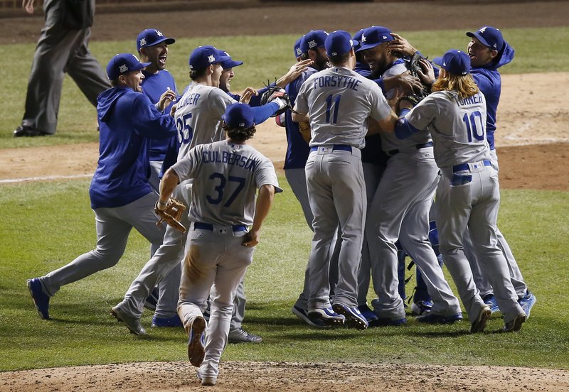 The Los Angeles Dodgers players celebrate after Game 5 of baseball's National League Championship Series against the Chicago Cubs, Thursday, Oct. 19, 2017, in Chicago. The Dodgers won 11-1 to win the series and advance to the World Series. 