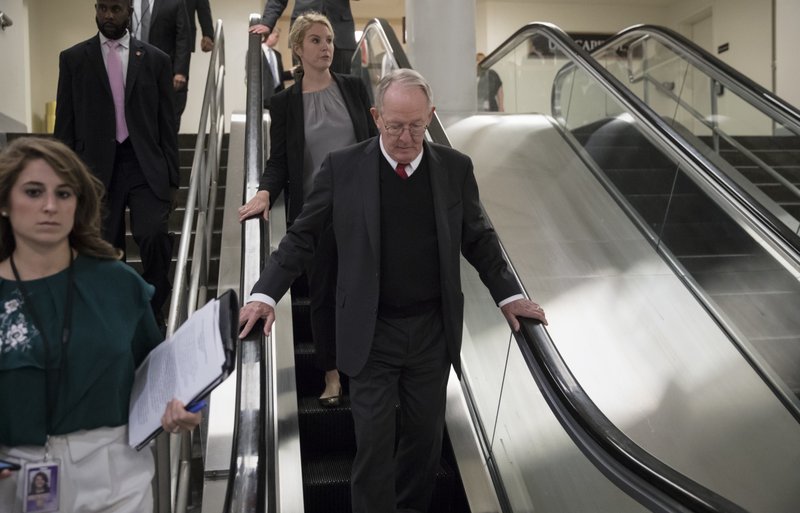 Sen. Lamar Alexander, R-Tenn., takes the escalator down as he returns to his office after appearing on the Senate floor with Sen. Patty Murray, D-Wash., to defend their bipartisan proposal for resuming federal subsidies to health insurers that President Donald Trump has blocked, at the Capitol in Washington, Thursday, Oct. 19, 2017. 