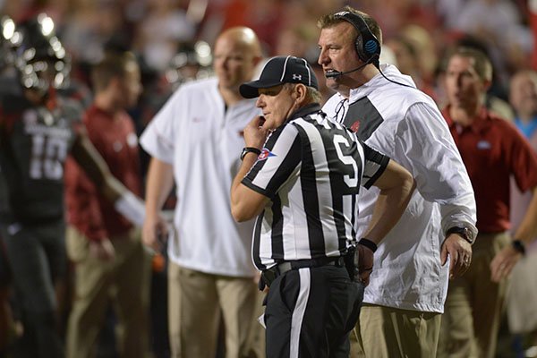 Arkansas coach Bret Bielema speaks with an official during a 52-20 loss to Auburn Saturday, Oct. 21, 2017, in Razorback Stadium in Fayetteville.