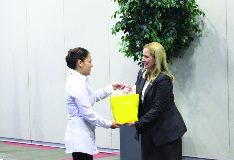 Arkansas Attorney General Leslie Rutledge, right, accepts a gift from South Arkansas Community College student Dee Guzman, president of the Phi Beta Lambda chapter, at an event Monday. Rutledge spoke about cyber security, identity theft and internet safety as part of the first annual SouthArk CyperExpo. 