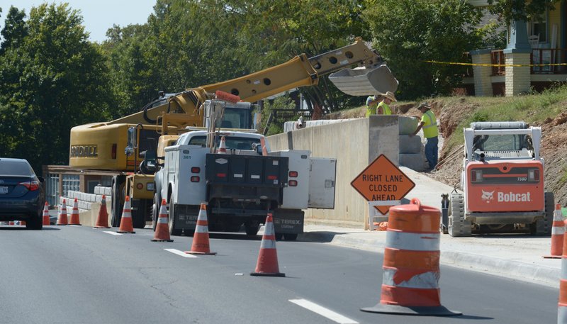 NWA Democrat-Gazette/ANDY SHUPE Transportation Division workers assemble a retaining wall Sept. 7 along College Avenue in Fayetteville.