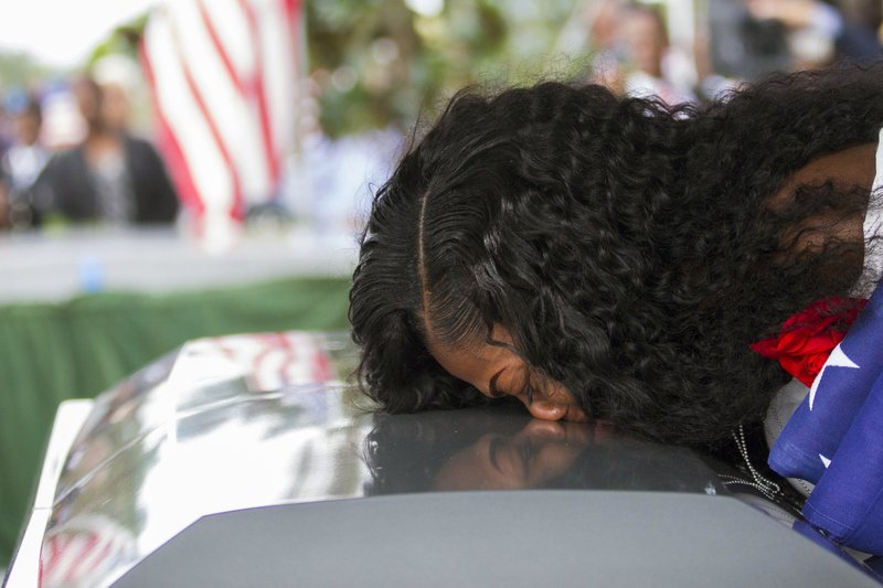 Myeshia Johnson, the widow of Army Sgt. La David Johnson, kisses her husband’s casket during funeral service at the Hollywood Memorial Gardens on Saturday in Hollywood, Fla.