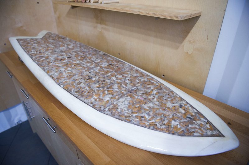 This Oct. 20, 2017, photo shows a surfboard that Taylor Lane of Santa Cruz, Calif., made with 10,000 discarded cigarette butts for the annual "Creators & Innovators Upcycle Contest" at the Ecology Center in San Juan Capistrano, Calif. 