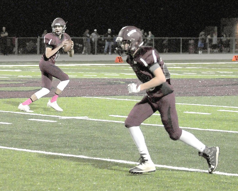 MARK HUMPHREY ENTERPRISE-LEADER Lincoln junior high quarterback Tyler Brewer drops back to pass looking left at a receiver just beginning his route. Brewer turned and threw right on this play after looking off the defense. Brewer completed 6 of 7 passes for 80 yards and a touchdown while leading Lincoln to a 38-22 win over Berryville on Thursday, Oct. 5.