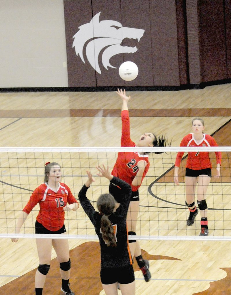 Photographs by Mark Humphrey Pea Ridge sophomore Kynley Burton, a 6-0 middle hitter, goes up high before drilling a kill against Gravette. The Lady Blackhawks punched their ticket to state with a 3-set (25-16, 25-13, 25-9) sweep of Gravette last Tuesday, Oct. 17 at the District 4A-1 volleyball tournament played at Lincoln.