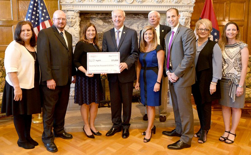 Submitted Photo Present at the presentation of Highfill's grant were AEDC grants manager Brenda Rowell, Mayor Stacey Digby, Cassie Elliott of Visionary Milestones, Governor Asa Hutchinson, AEDC executive VP of operations Amy Fecher, ARDC commissioner Glenn Priebe, AEDC executive director Mike Preston, ARDC commissioner Lynn Hawkins, ARDC commissioner Elizabeth Walker.