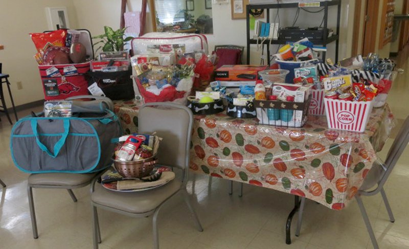 Photo by Susan Holland This tableful of goodies is only a small part of the prizes that will be available at the bingo night fundraiser Saturday at the Billy V. Hall Senior Activity and Wellness Center. Prizes include a tailgate party, movie night and pasta night baskets, DVD players, gardening and pet items, personal care items and ballgame tickets. Bingo cards will be $5 each, and bingo play begins at 5:30 p.m. Proceeds benefit the Meals on Wheels program.