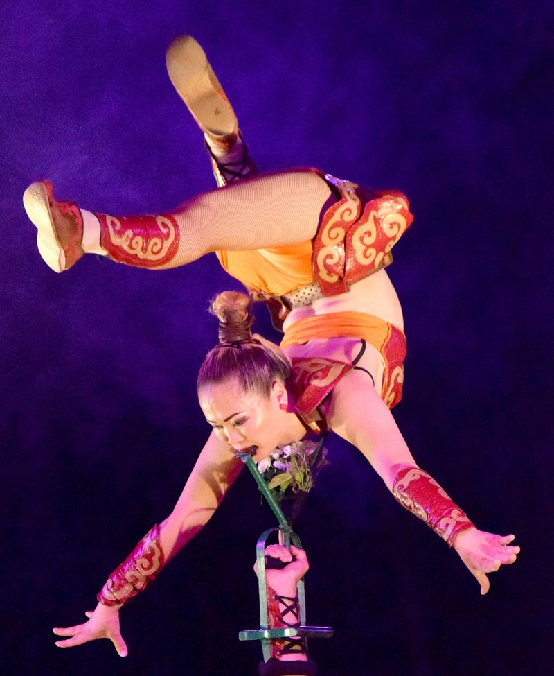 Photo by Mike Eckels Zaya, a member of the Mongolian Masters of Balance, is suspended high over her partner Mendee's head, supported by her teeth, during the Kelly Miller Circus at Veterans Park in Decatur Oct. 20.