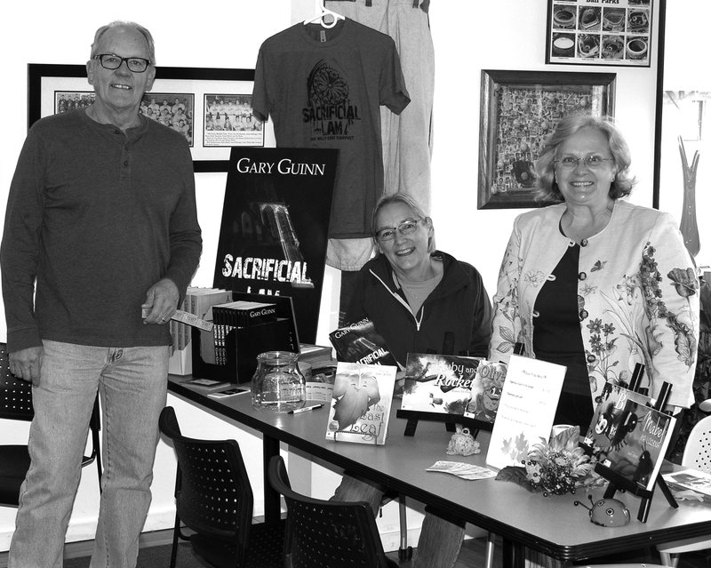 Submitted Photo Local authors Gary Guinn, Mary Ann Guinn and Dawn Denton conduct a book signing at the Gentry Public Library anniversary celebration on Friday.