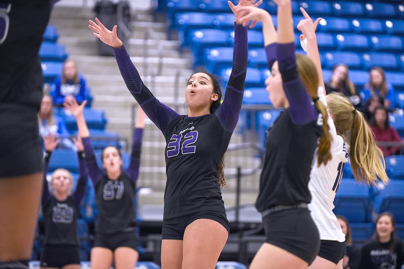 Fayetteville’s Haley Warner (32) celebrates a point with her teammates Tuesday during the Lady Bulldogs’ first-round win against Bryant during the state volleyball tournament in Conway.