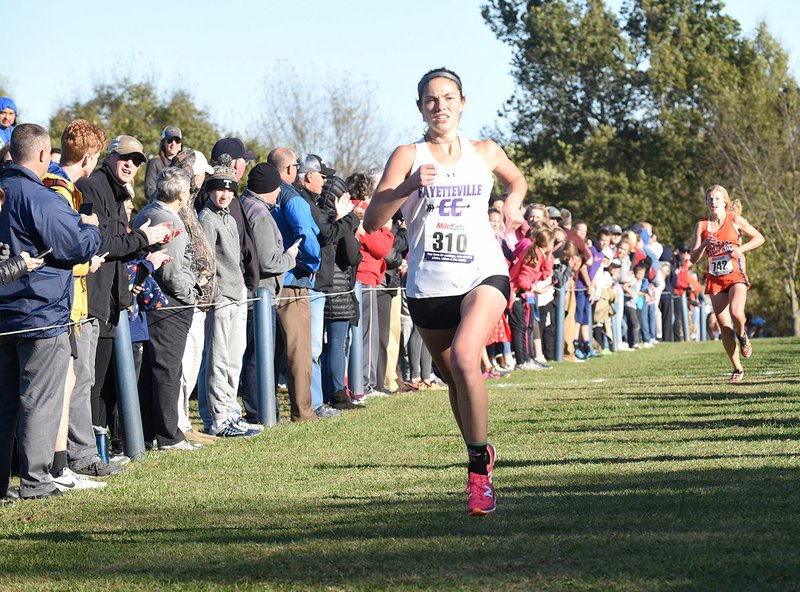 Fayetteville’s Rebecca Boushelle approaches the finish line as the winner of the girls’ 7A-West Conference cross country championship Tuesday in Rogers.
