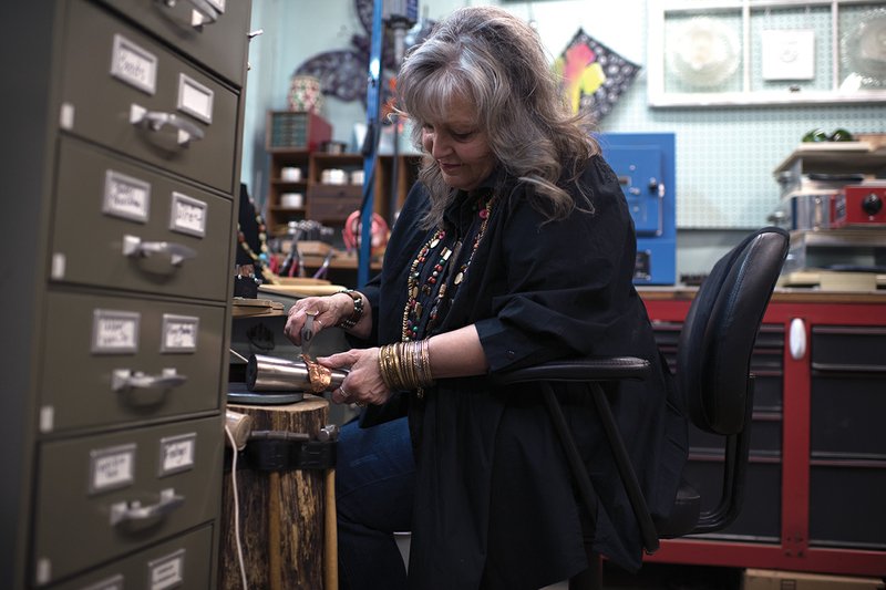 Kathi Raines works inside The Artistry in Searcy. Raines, owner of The Artistry, said the business is a group of 35 local artists who sell their art at the shop, teach classes and offer custom work.