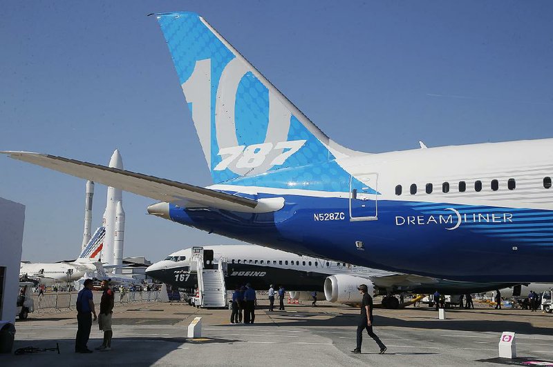 People stand near a Boeing 787-10 Dreamliner on the eve of the Paris Air Show’s opening in June. Boeing said Wednesday that third-quarter sales rose 2 percent to $3.67 billion.   
