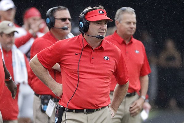 In this Oct. 7, 2017, file photo, Georgia head coach Kirby Smart, center, watches the action from the sideline in the first half of an NCAA college football game against Vanderbilt in Nashville, Tenn. No. 1 Alabama and No. 3 Georgia are on track to give the SEC two undefeated teams in the championship game for the first time since 2009. (AP Photo/Mark Humphrey, File)