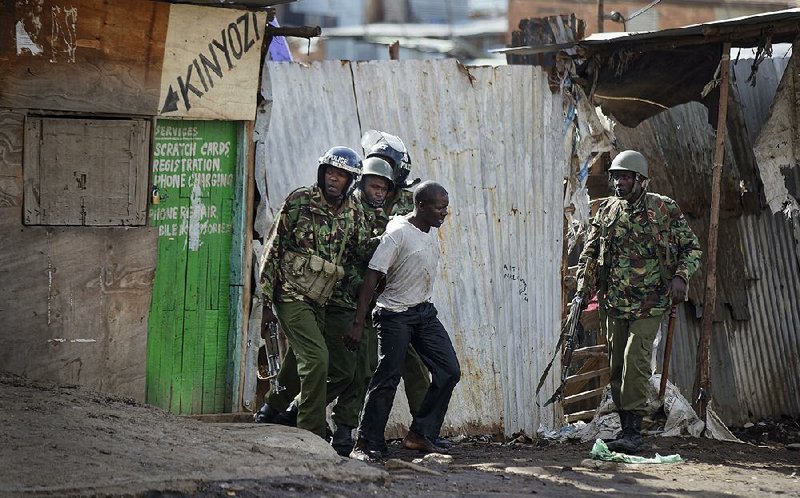 Kenyan riot police arrest an opposition protester Thursday in the Mathare slum in Nairobi. 
