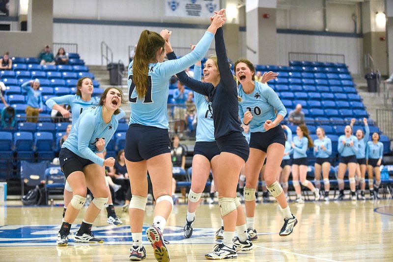 Springdale Har-Ber volleyball players celebrate a point Thursday during their come-from-behind win against Conway in the Class 7A state volleyball tournament at Buzz Bolding Arena in Conway.