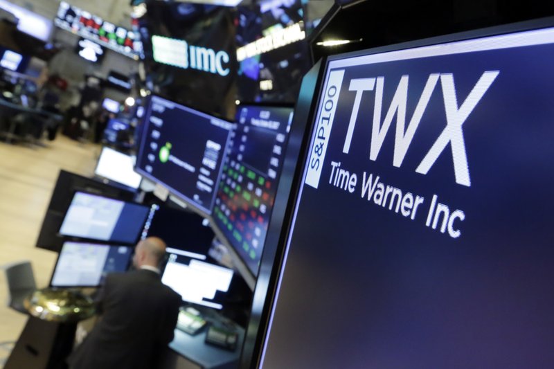 The symbol for Time Warner appears on a board above the floor of the New York Stock Exchange, Thursday, Oct. 26, 2017. Time Warner Inc. reported financial results for its third quarter that ended Sept. 30, 2017. (AP Photo/Richard Drew)